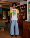 Jerrod is wearing Short Sleeve Raglan Tee in Mushrooms paired with light wash Indigo Wide Leg Trousers