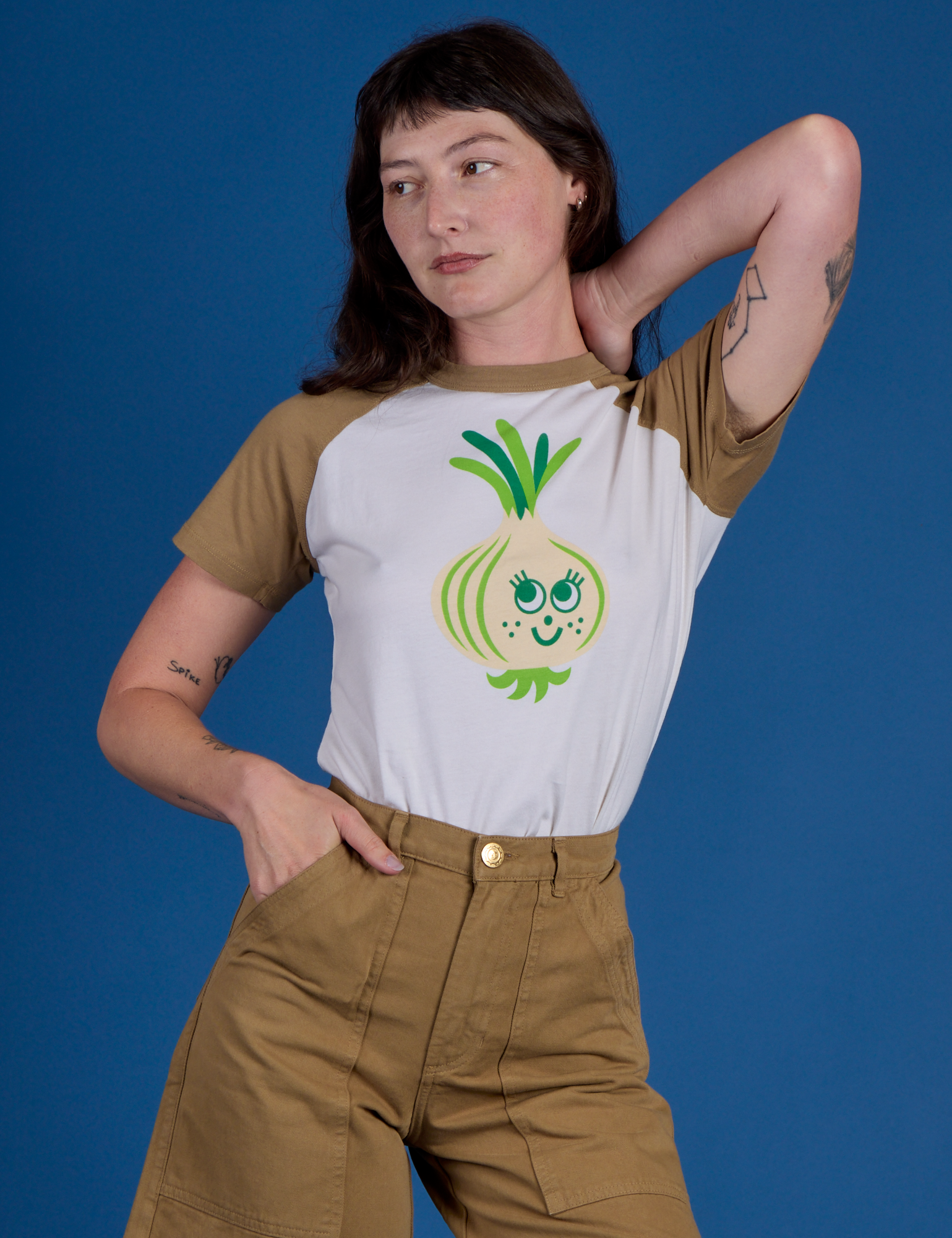 Alex is wearing Produce Raglan Tee in Onion