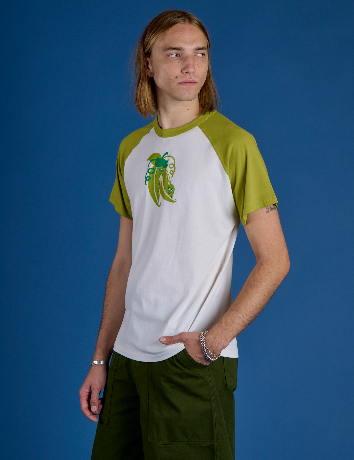 Angled front view of Produce Raglan Tee in Snap Peas on Grant