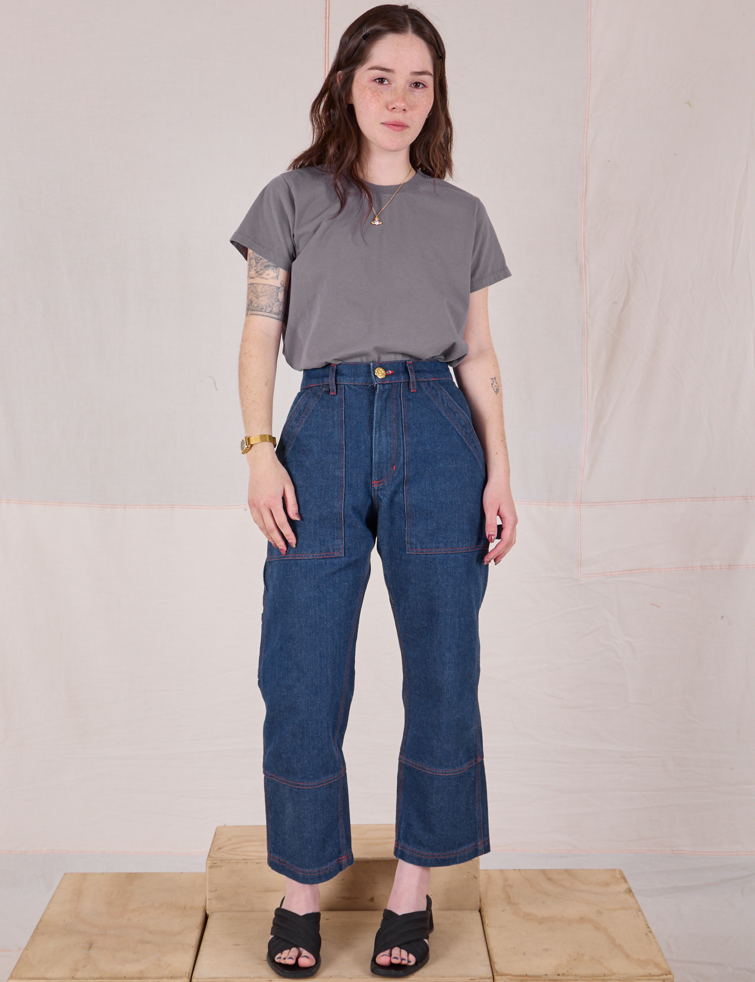 Hana is wearing Organic Vintage Tee in Washed Grey tucked into dark wash Carpenter Jeans