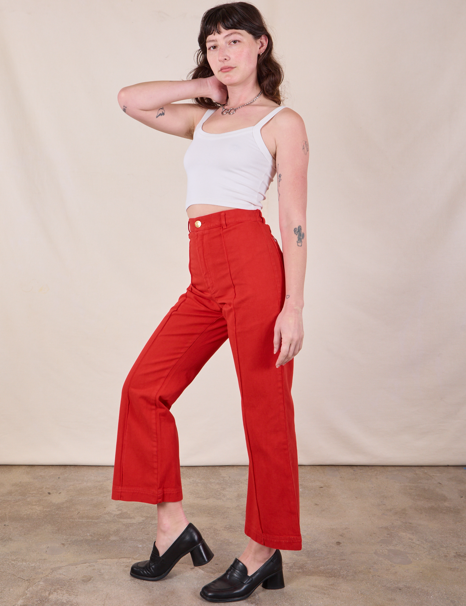 Side view of Western Pants in Mustang Red and Cropped Cami in Vintage Tee Off-White on Alex