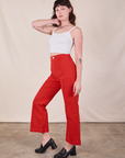 Side view of Western Pants in Mustang Red and Cropped Cami in Vintage Tee Off-White on Alex