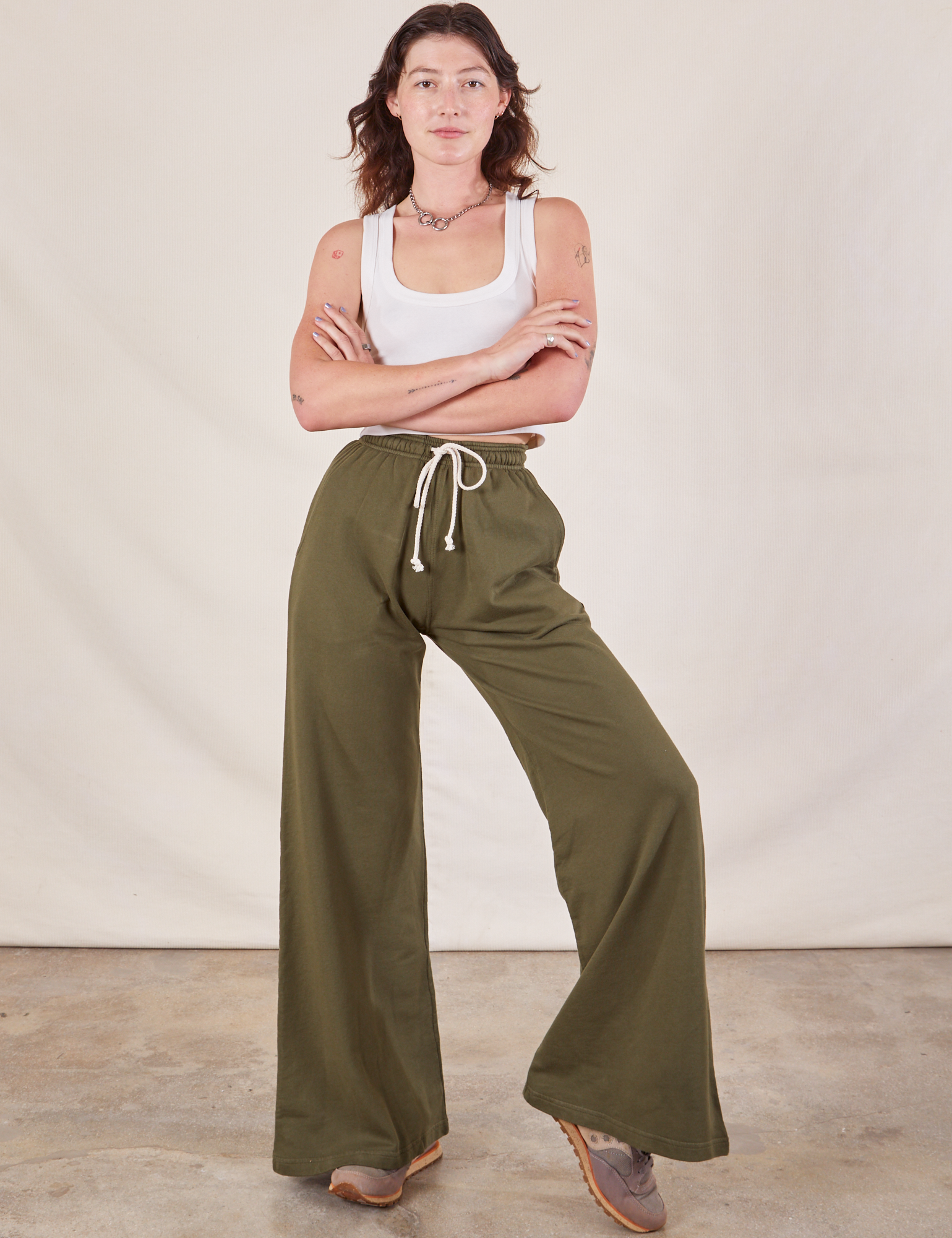 Alex is wearing Wide Leg Sweat Pants in Surplus Green and Cropped Tank in vintage tee off-white