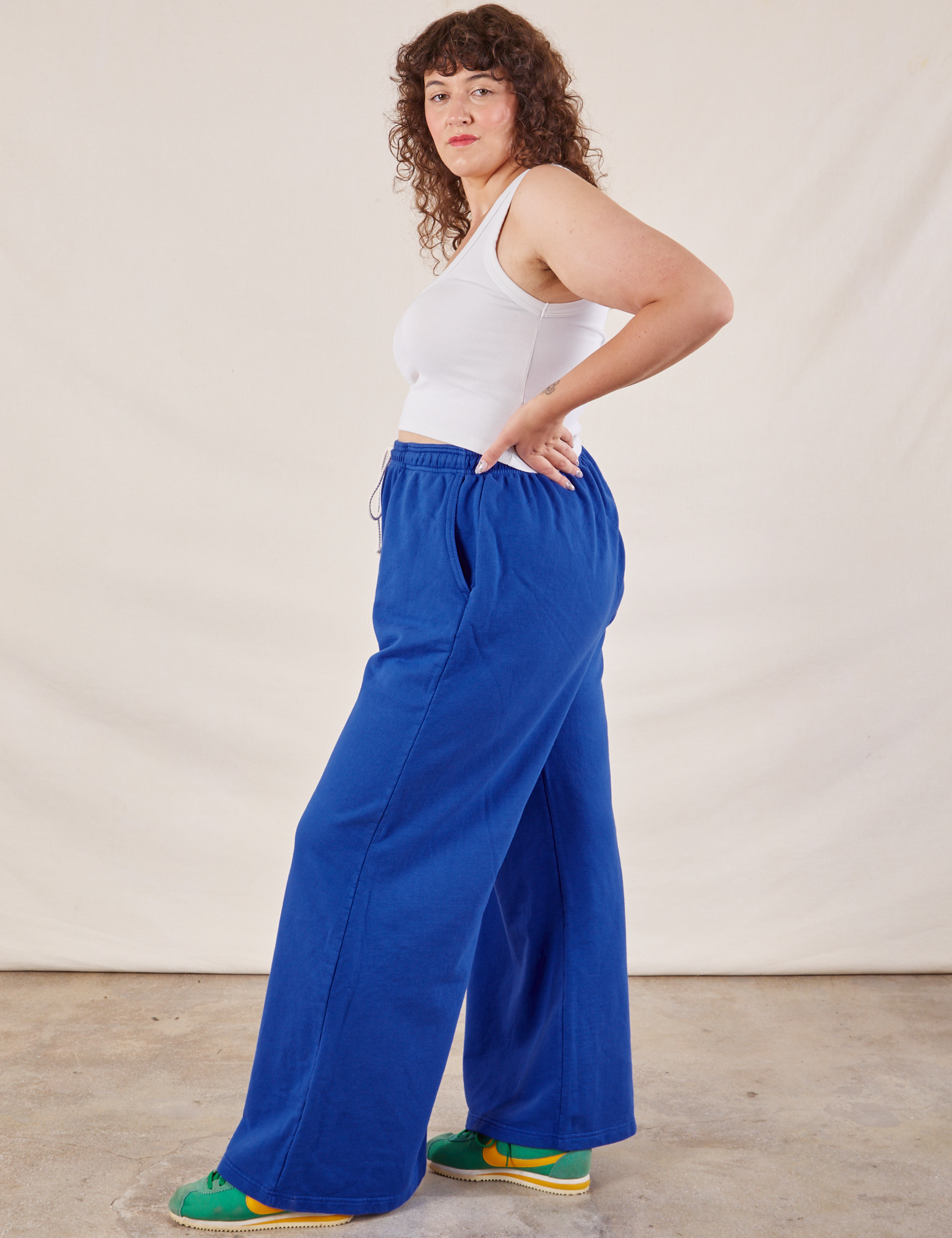 Side view of Wide Leg Sweat Pants in Royal Blue and Cropped Tank on Ryan