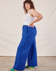 Side view of Wide Leg Sweat Pants in Royal Blue and Cropped Tank on Ryan