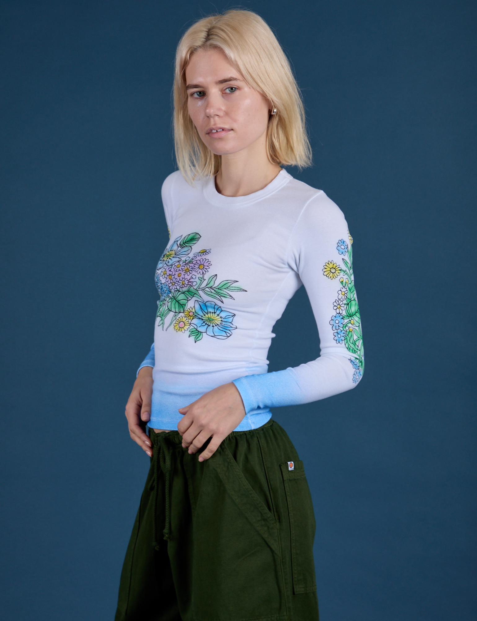 Angled front view of Floral Long Sleeve Baby Tee in Baby Blue on Madeline
