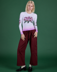 Madeline is wearing Floral Long Sleeve Baby Tee in Pink and Drop Pocket Cargo Pants in Red Wine