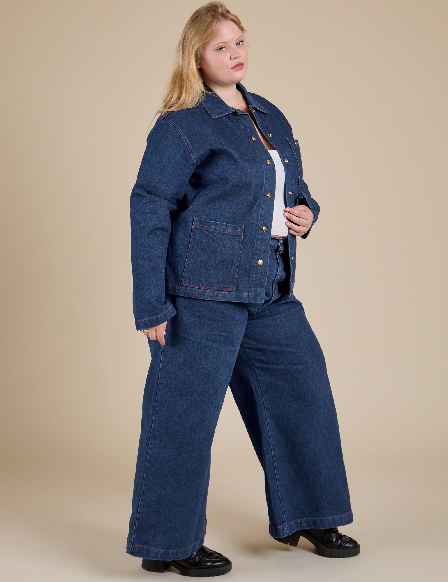 Angled front view of Indigo Denim Work Jacket in Dark Wash and dark wash Indigo Wide Leg Trousers