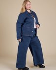 Angled front view of Indigo Denim Work Jacket in Dark Wash and dark wash Indigo Wide Leg Trousers