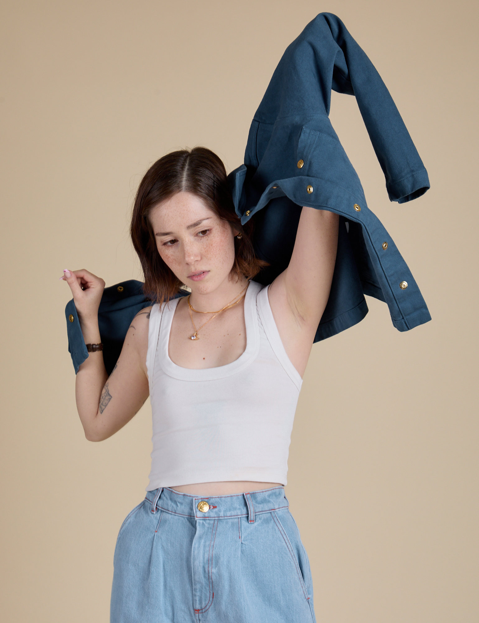Hana is putting on the Denim Work Jacket in French Blue