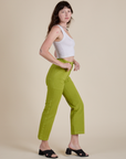 Side view of Work Pants in Gross Green and Cropped Tank in Vintage Tee White