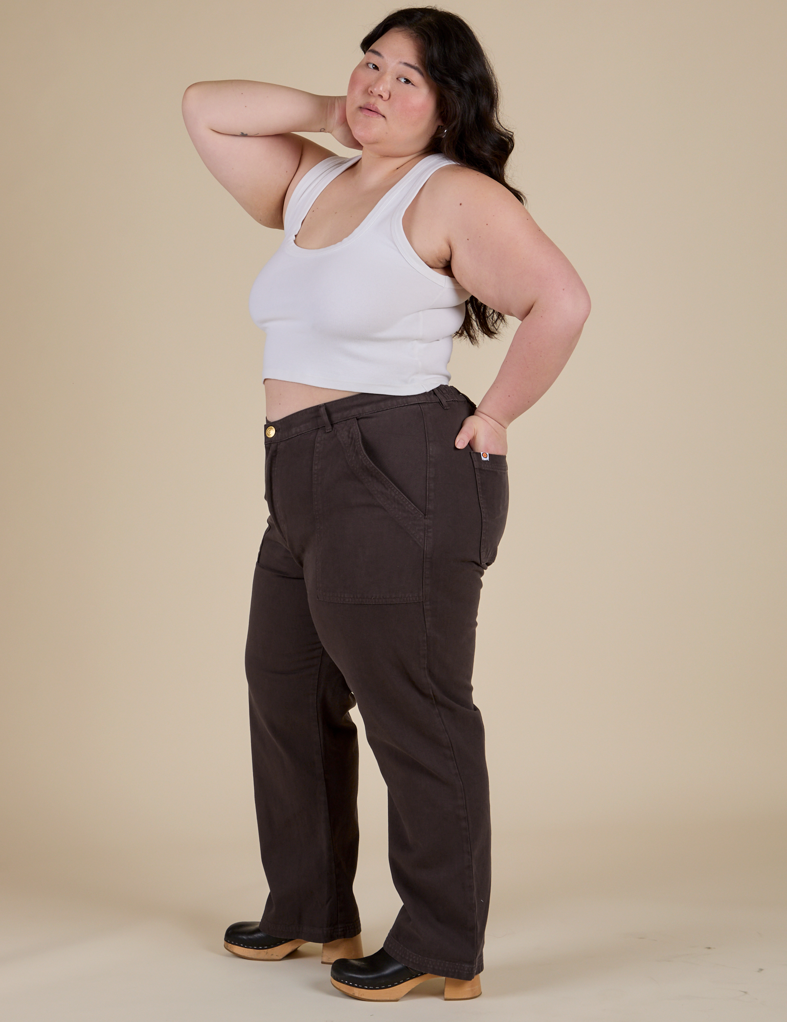 Side view of Work Pants in Espresso Brown and Cropped Tank in Vintage Tee White on Ashley