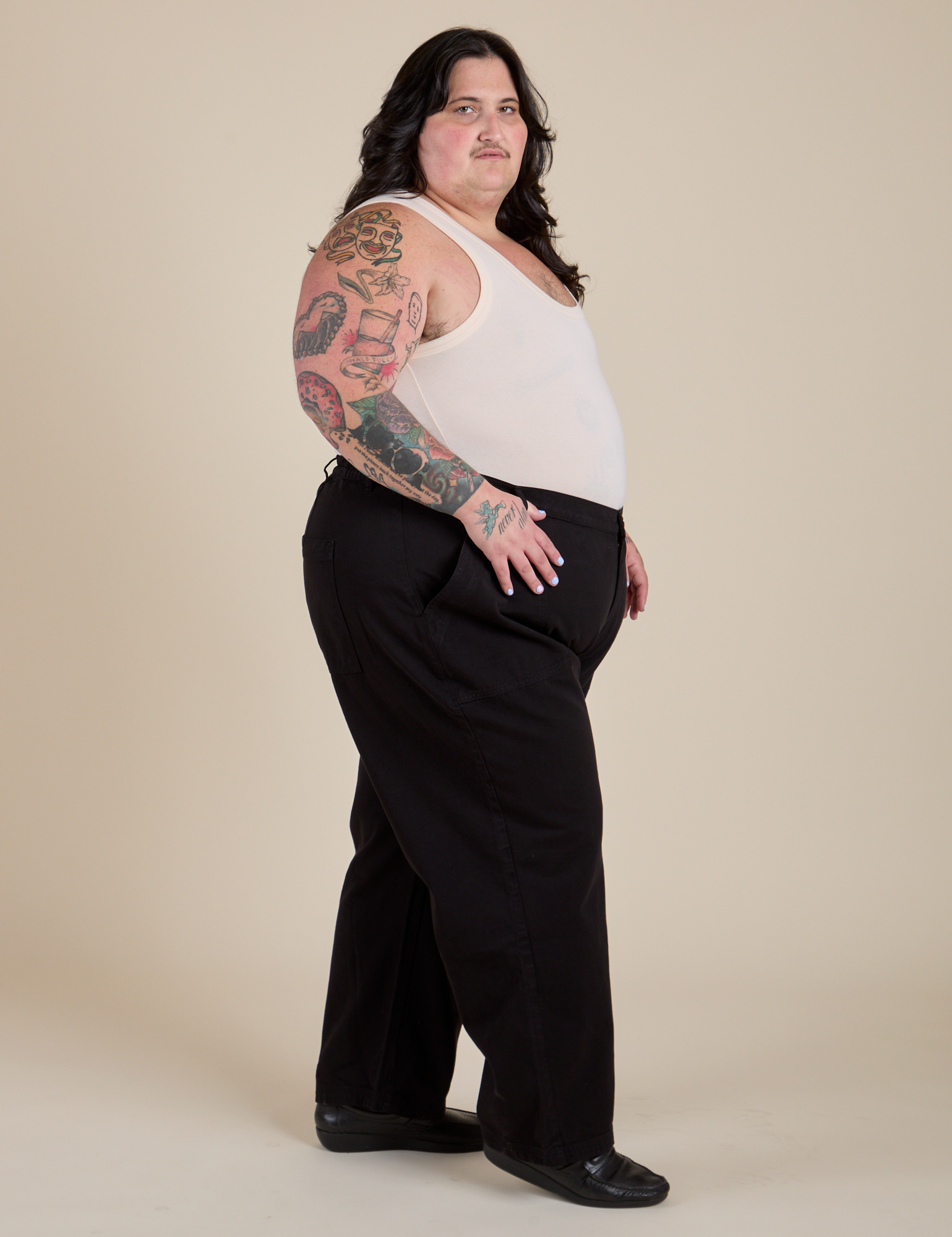 Side view of Work Pants in Basic Black and Tank Top in Vintage Tee Off-White on Sam