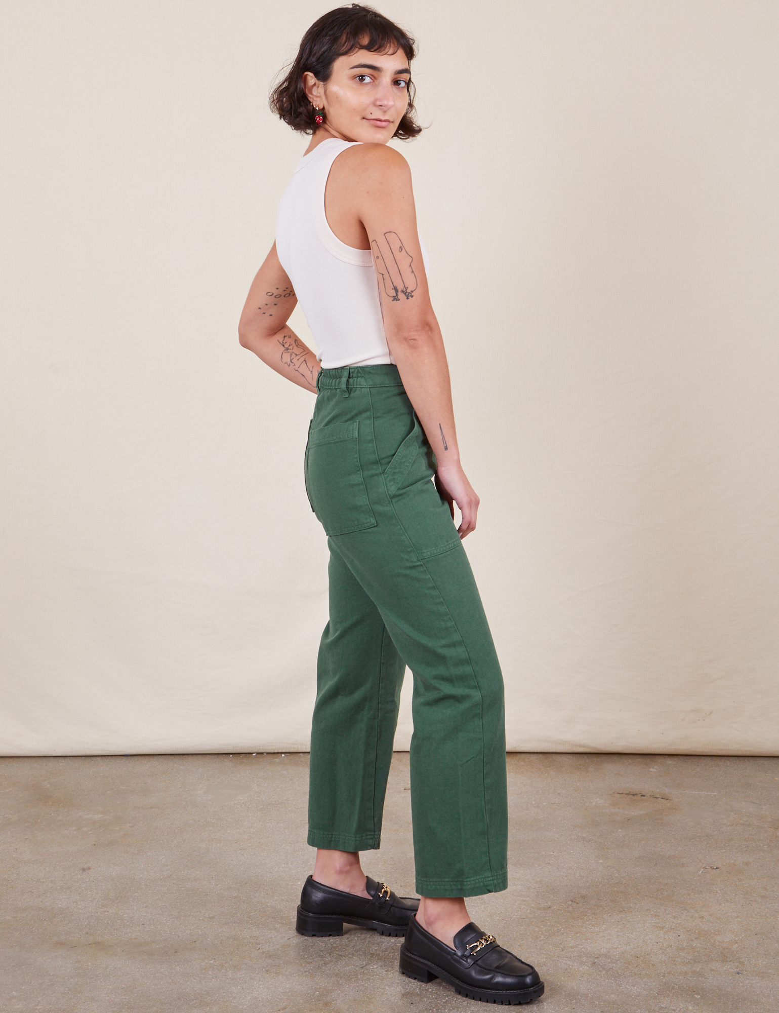 Work Pants in Dark Emerald Green side view on Soraya wearing vintage off-white Tank Top