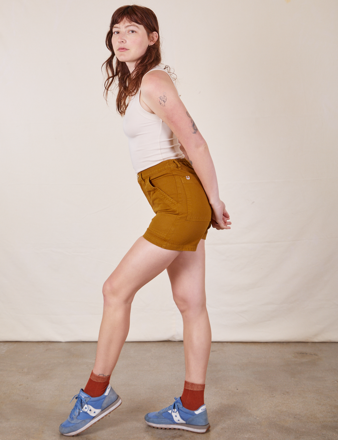 Side view of Classic Work Shorts in Spicy Mustard and vintage off-white Tank Top worn by Alex