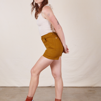 Side view of Classic Work Shorts in Spicy Mustard and vintage off-white Tank Top worn by Alex