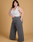 Angled front view of Heritage Wide Leg Trousers in Washed Grey and Cropped Tank in Vintage Tee White on Ashley
