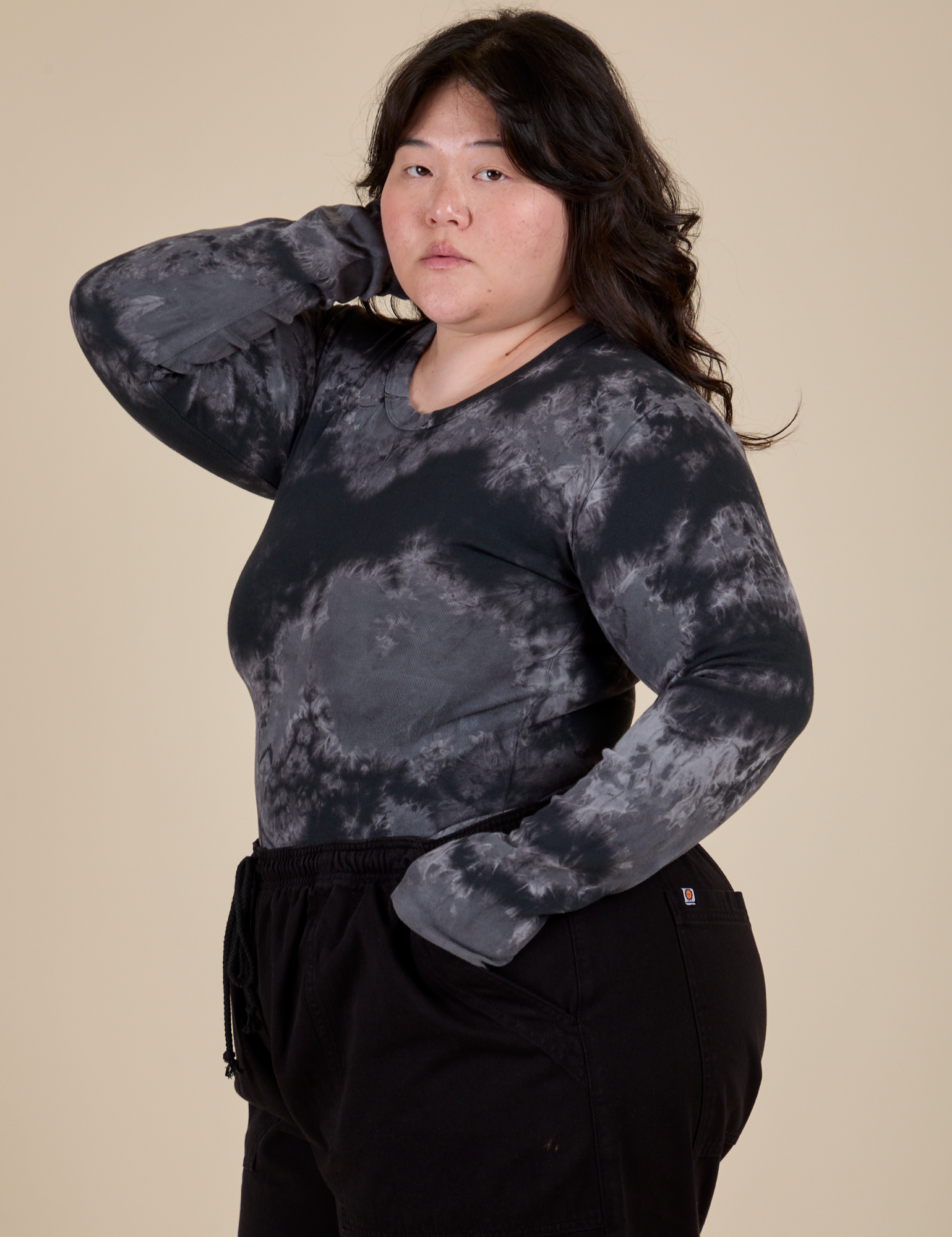 Angled front view of Long Sleeve Baby Tee in Black Magic Waters on Ashley