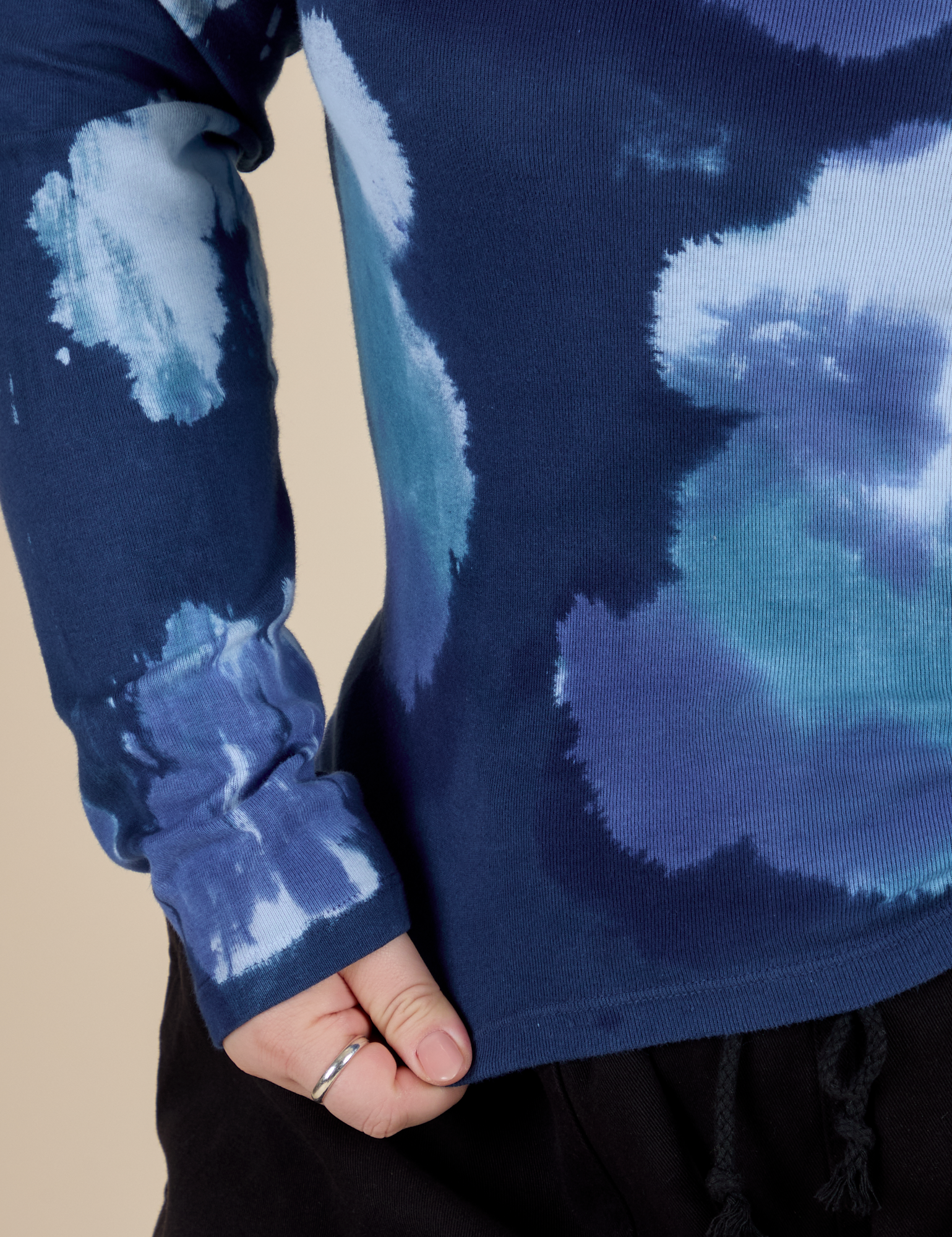 Long Sleeve Baby Tee in Blue Magic Waters bottom close up with Ashley pulling the hem