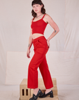 Side view of Mid-Rise Work Pants in Mustang Red and Cropped Cami on Alex