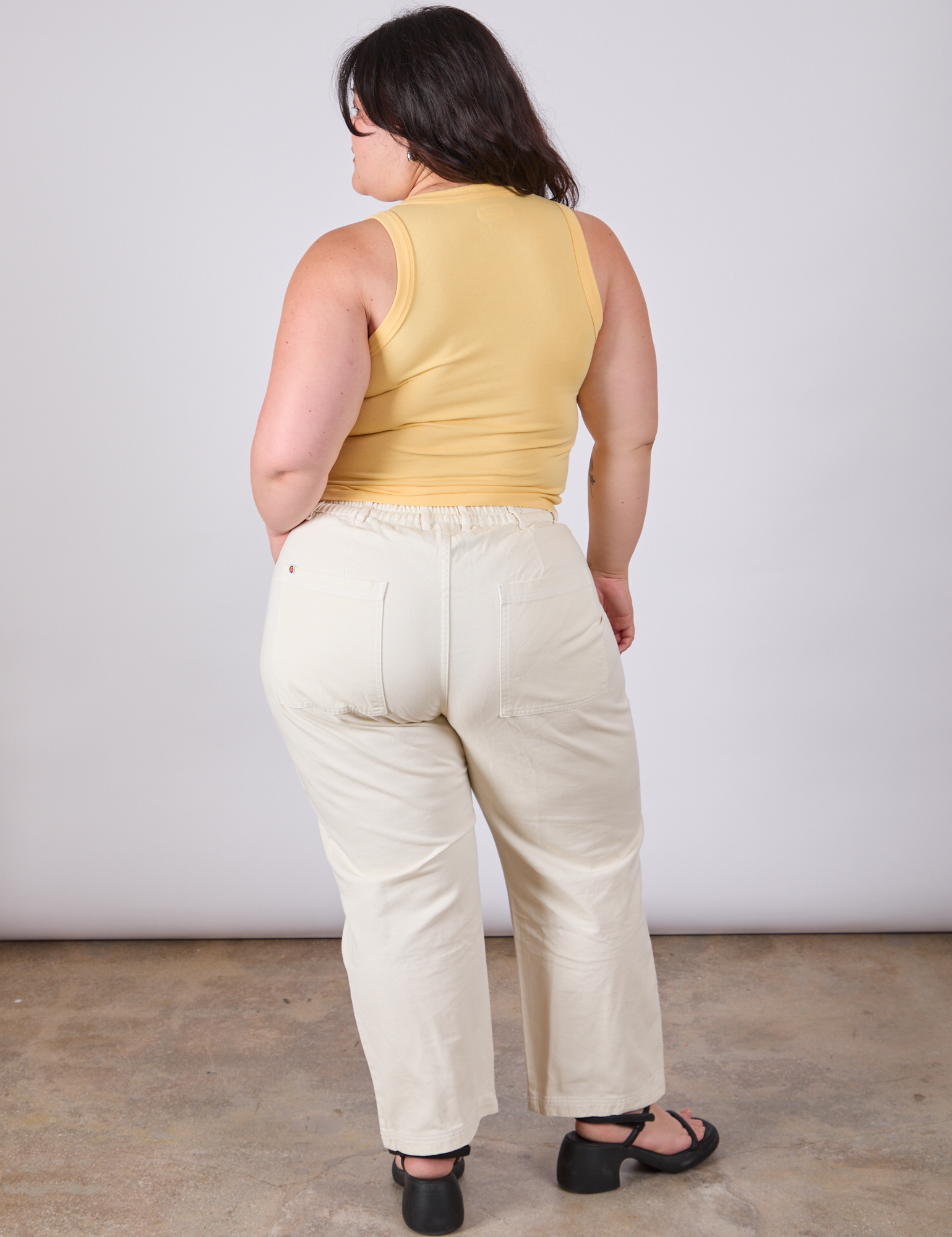 Back view of Tank Top in Butter Yellow and vintage tee off-white Work Pants on Ashley