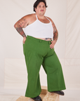 Angled view of Bell Bottoms in Lawn Green and vintage off-white Halter Top