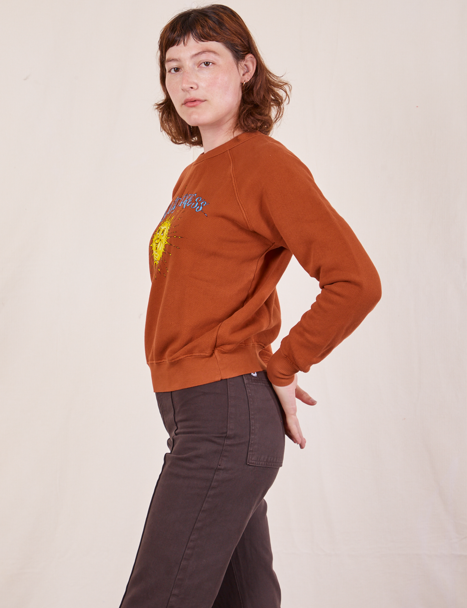 Side view of Bill Ogden&#39;s Sun Baby Crew and espresso brown Western Pants