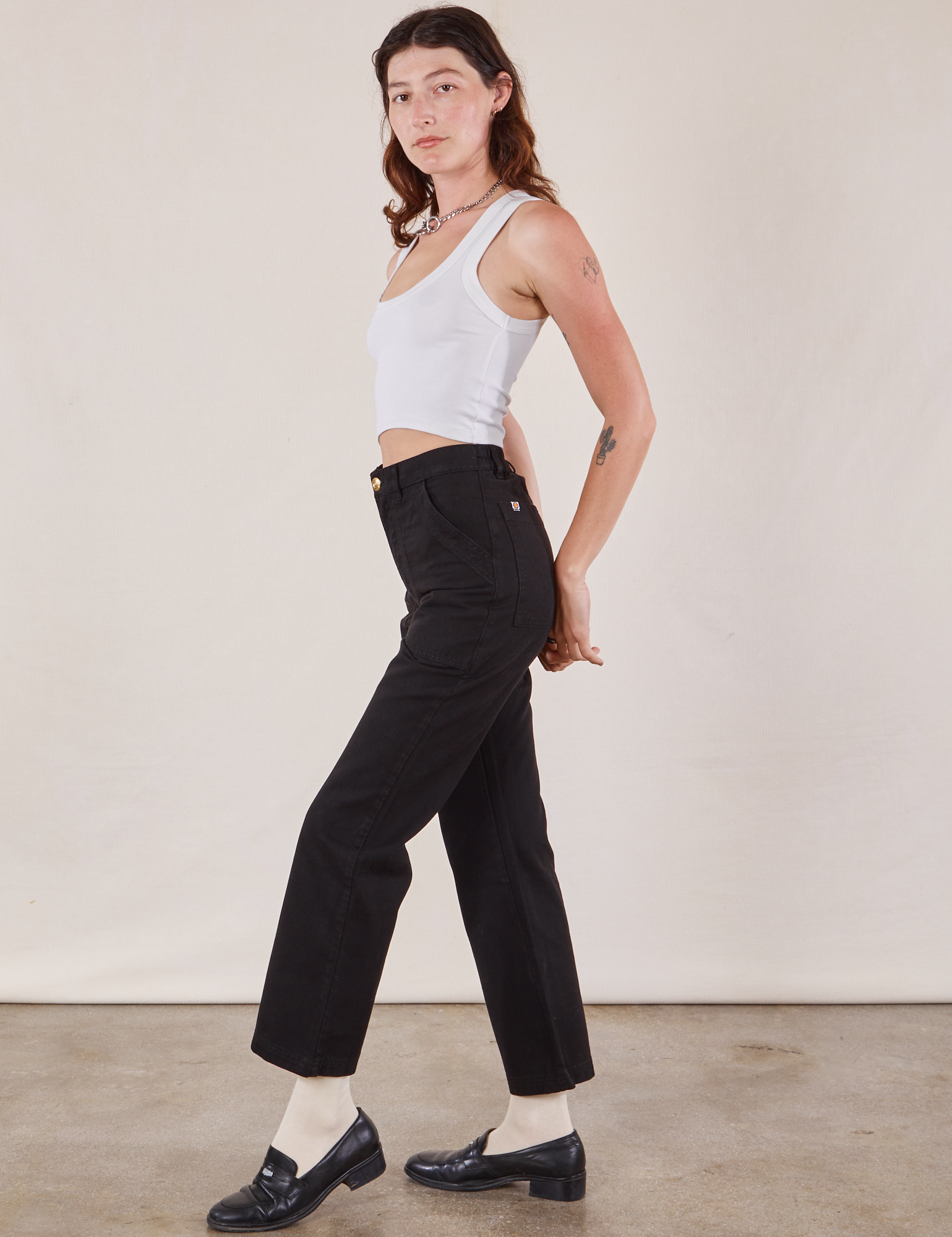 Side view of Work Pants in Black and Cropped Tank in vintage tee off-white