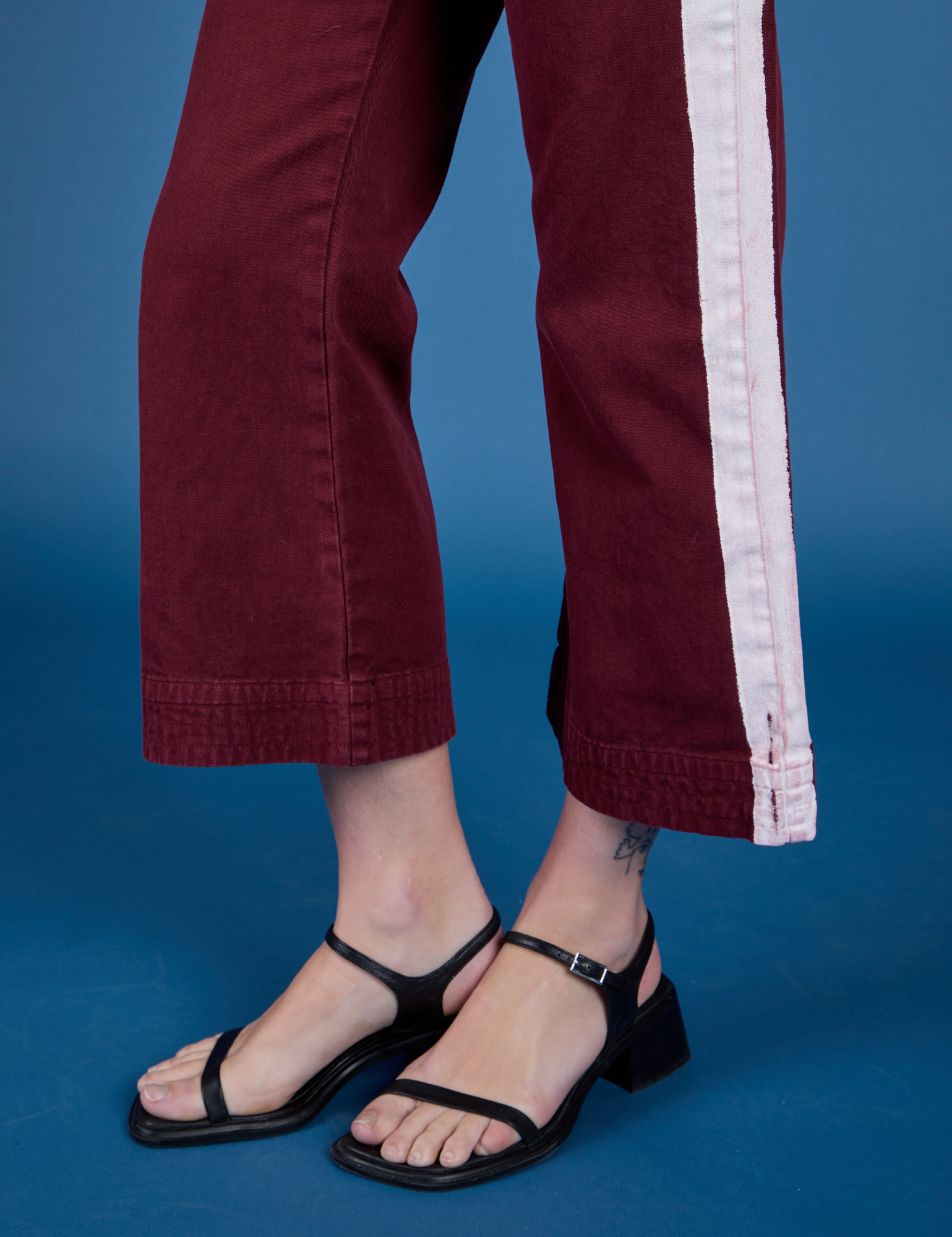 Painted Action Pants in Red Wine pant leg close up on Alex