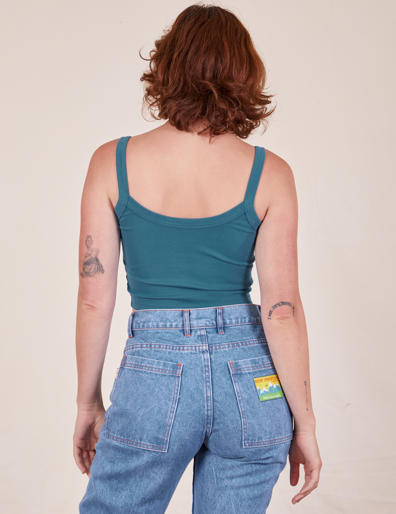 Back view of Cropped Cami in Marine Blue and light wash Frontier Jeans worn by Alex