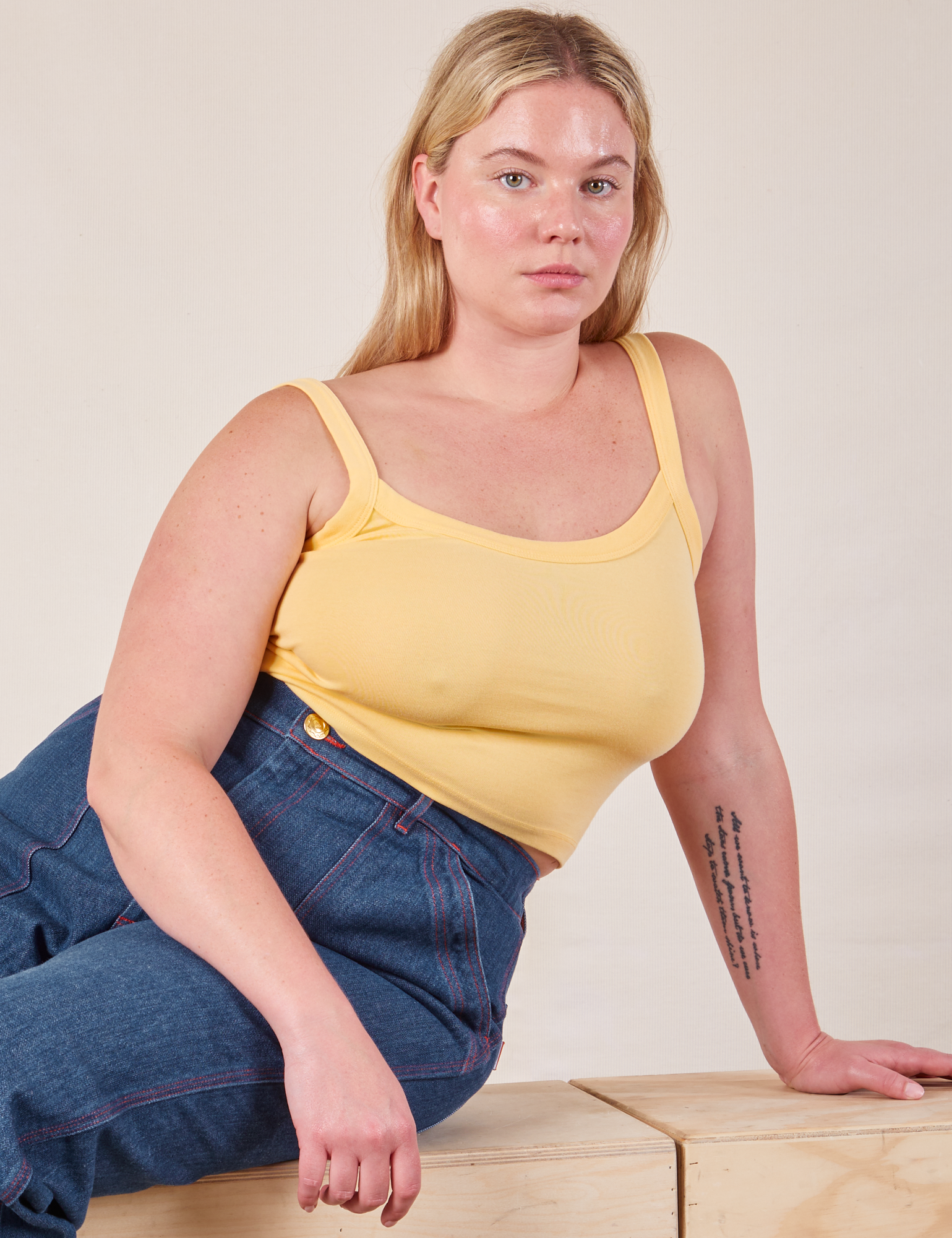 Lish is wearing Cropped Cami in Butter Yellow and dark wash Carpenter Jeans