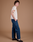 Side view of Carpenter Jeans in Dark Wash and Organic Vintage Tee in Vintage Tee Off-White on Quinn