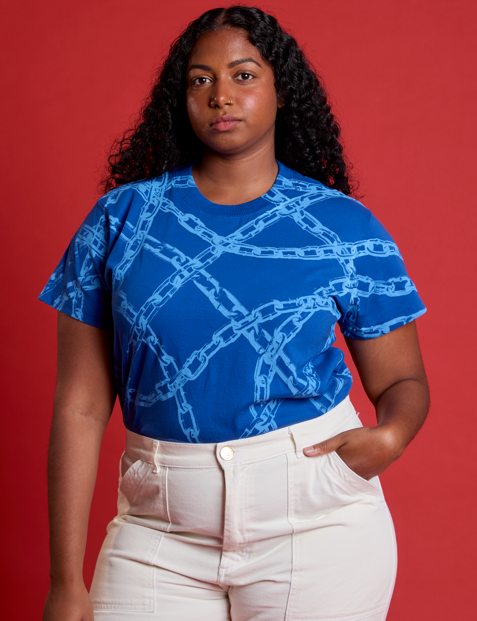 Meghna is wearing Chain Link Vintage Tee in Royal Blue tucked in vintage tee off-white Western Pants
