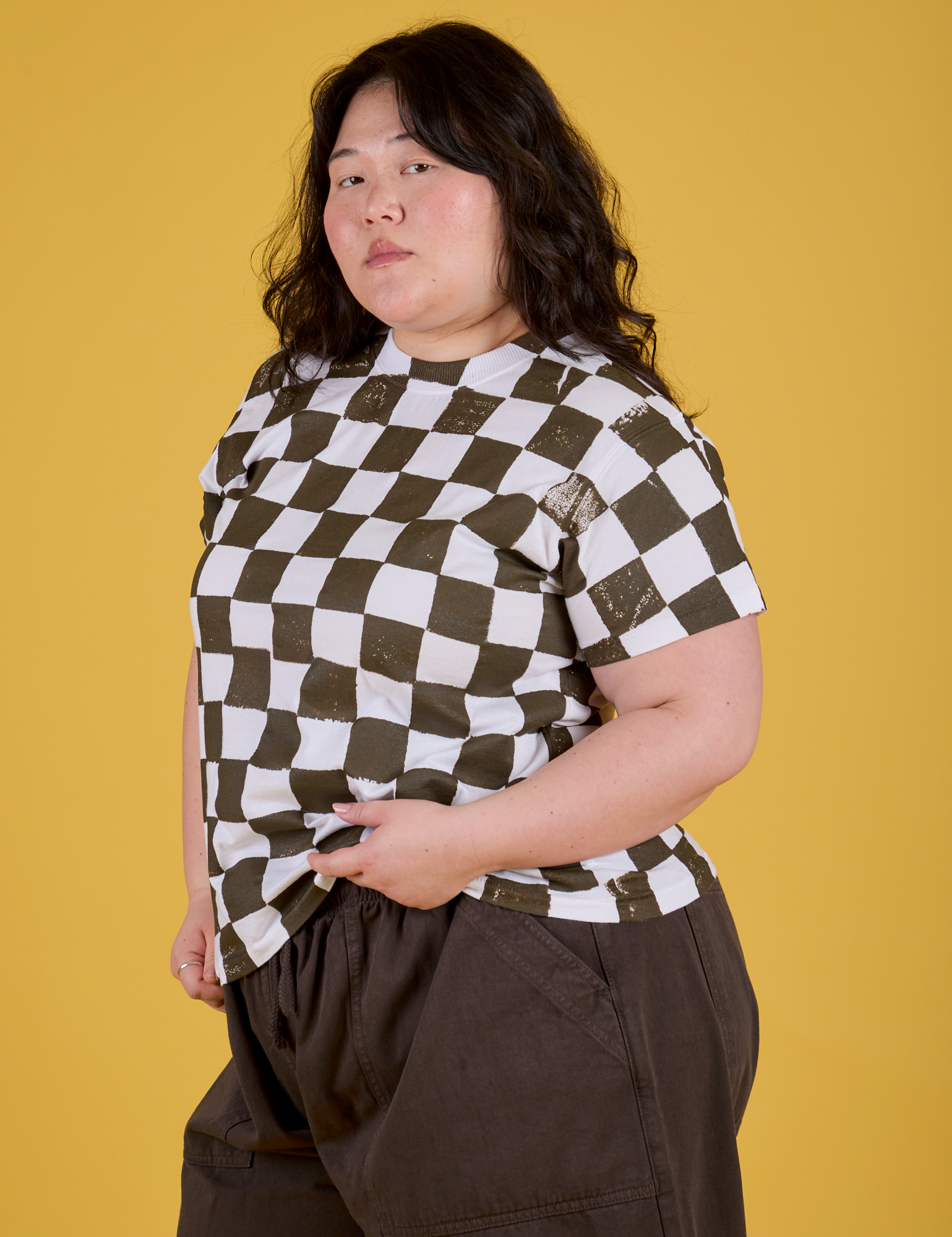 Angled front view of Checker Organic Tee in Espresso Brown on Ashley