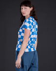 Angled back view of Checker Organic Tee in Blue on Alex