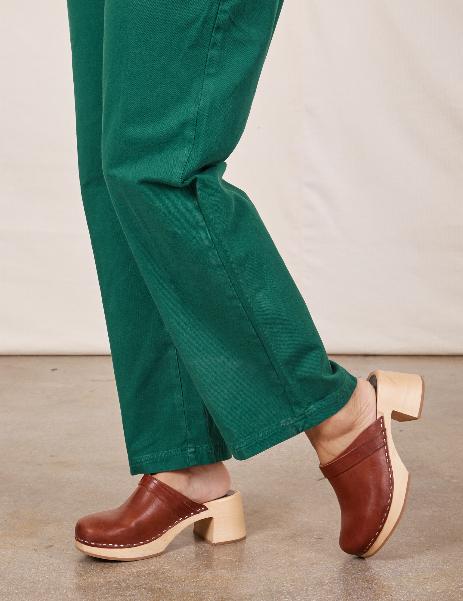 Side view pant leg close up of Short Sleeve Jumpsuit in Hunter Green on Tiara