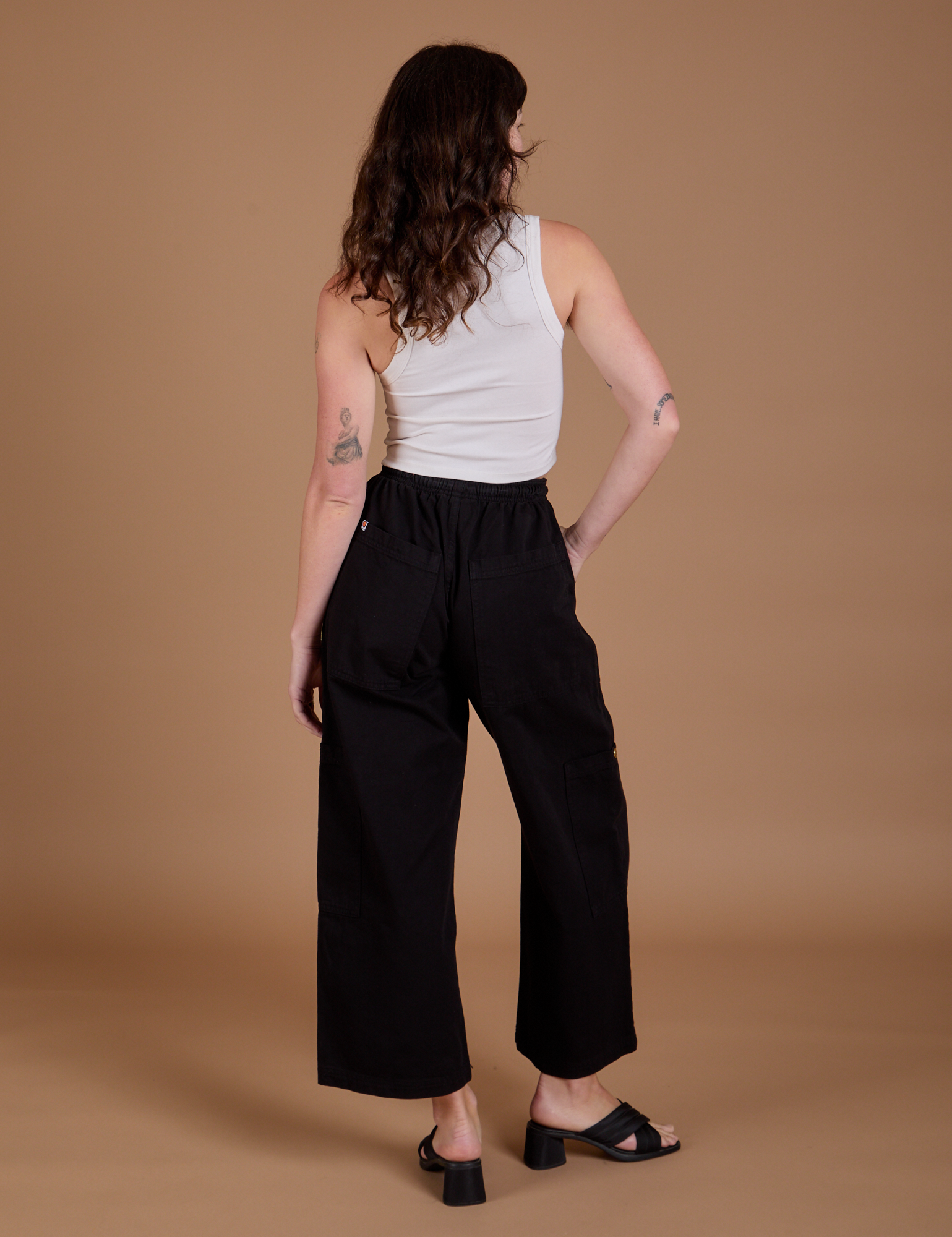 Drop Pocket Cargo Pants in Basic Black back view on Alex
