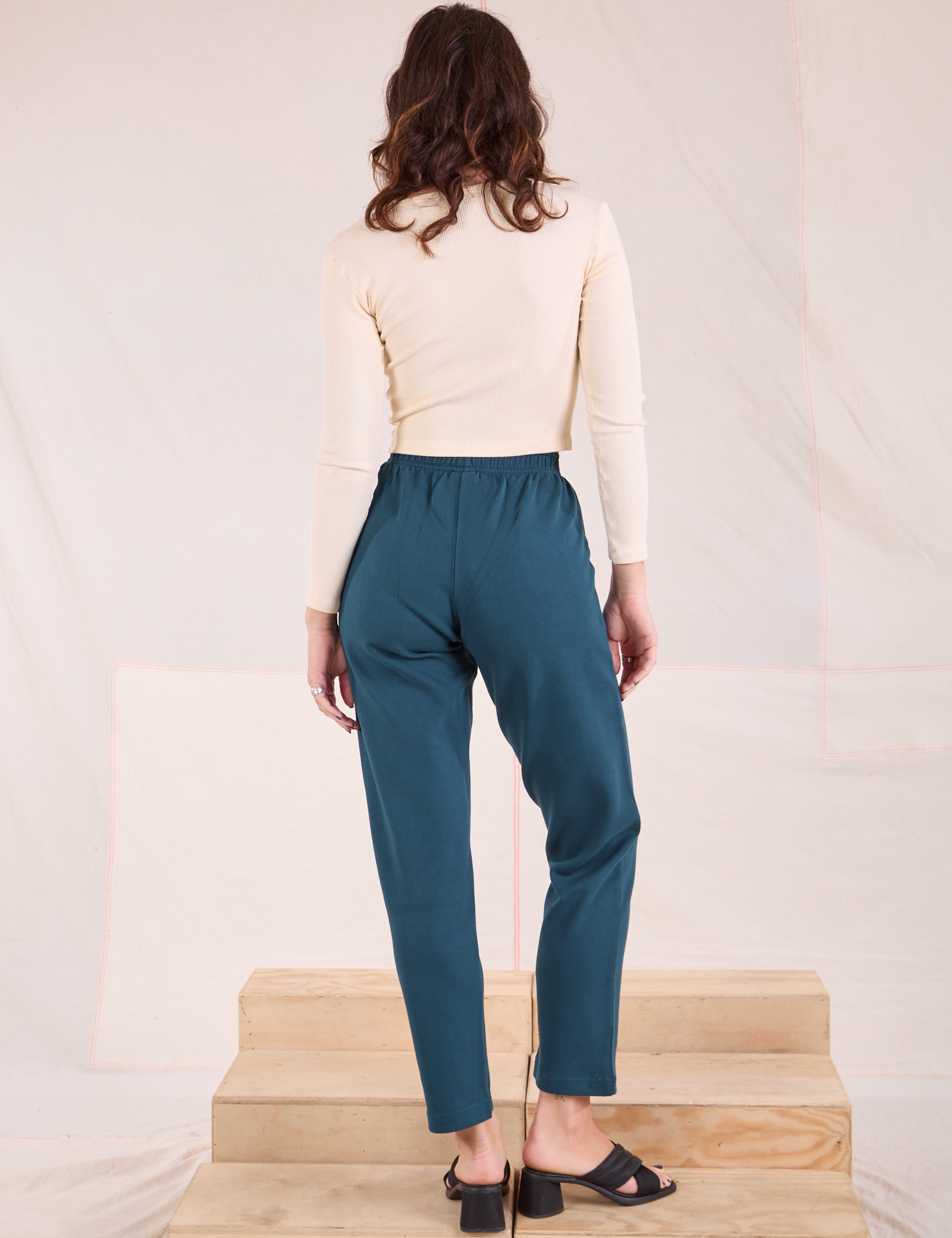 Back view of Easy Pants in Lagoon and vintage tee off-white Long Sleeve V-Neck Tee on Alex