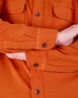 Sleeve close up of Flannel Overshirt in Burnt Orange worn by Alex