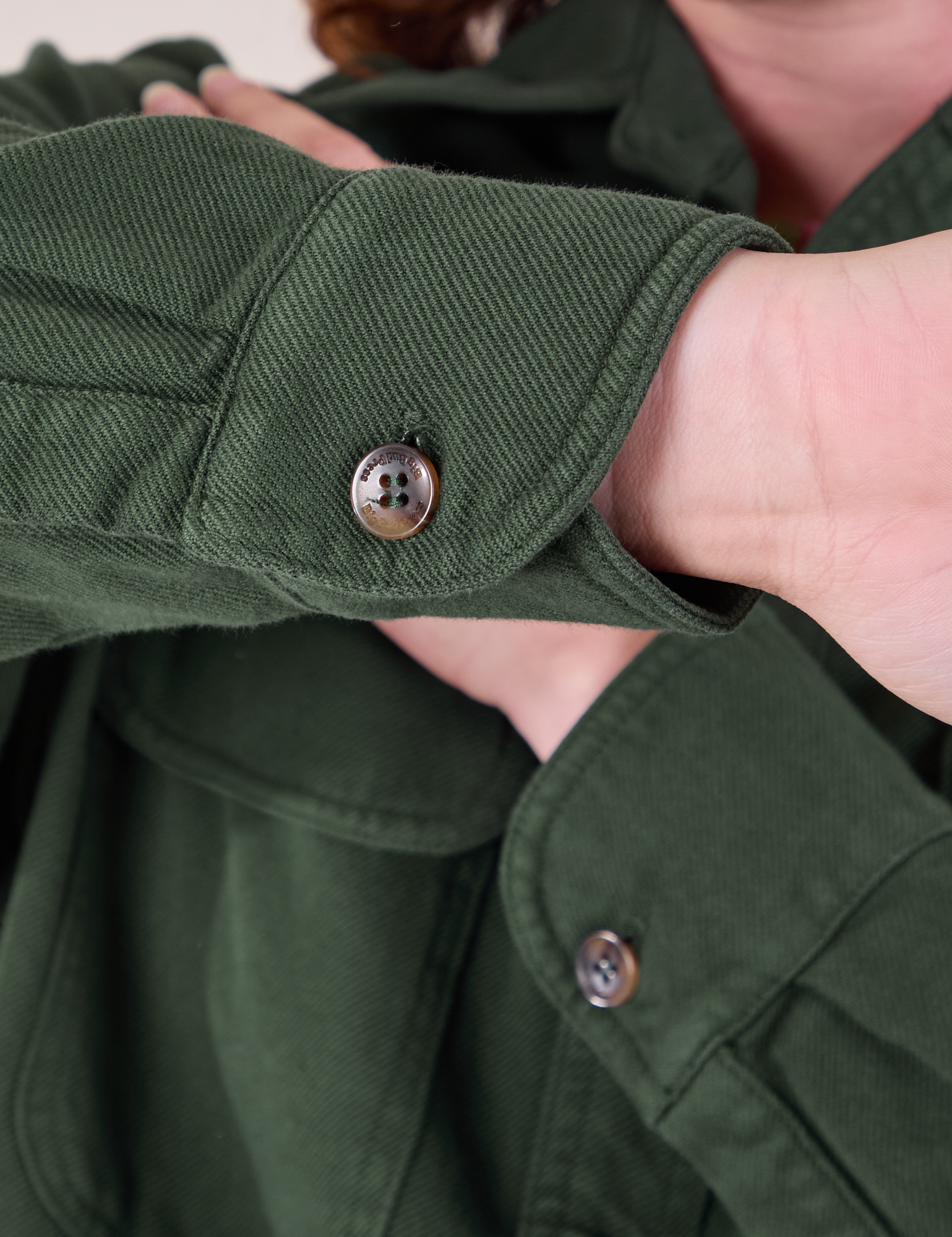 Flannel Overshirt in Swamp Green sleeve cuff close up showing custom tortoise shell buttons