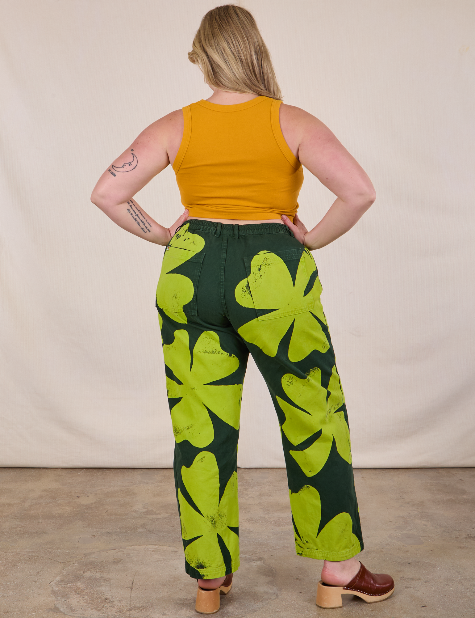 Back view of Paintstamped Clover Work Pant and Mustard Yellow Cropped Tank