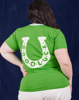 Back view of Luck Tee on Ashley. White horseshoe with 'good luck'