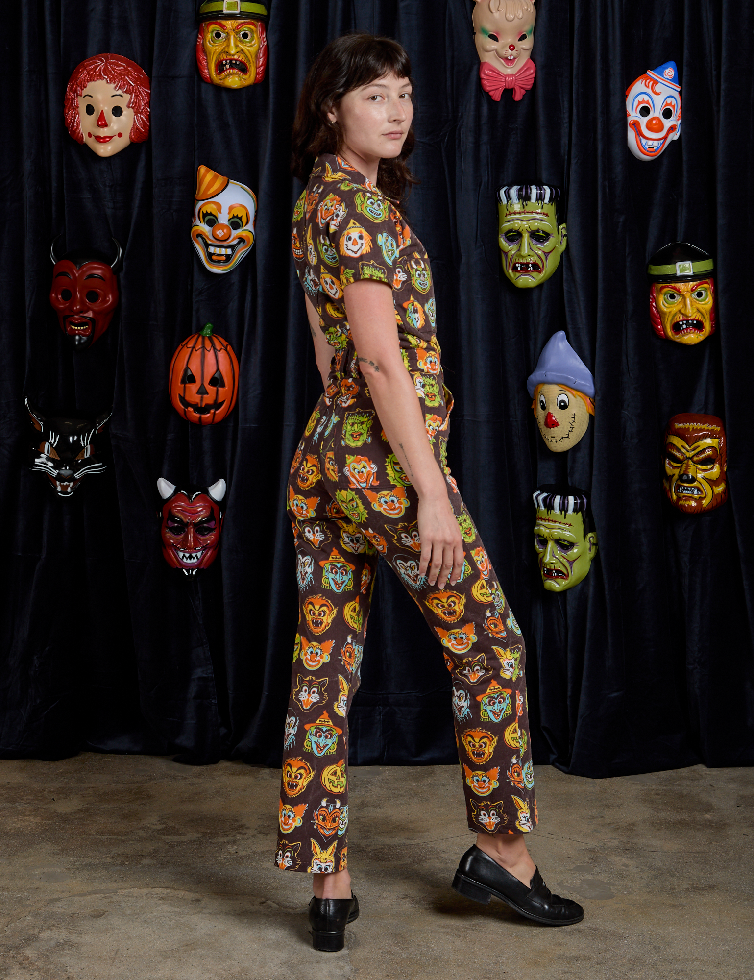 Short Sleeve Jumpsuit in Halloween Masks side view on Alex