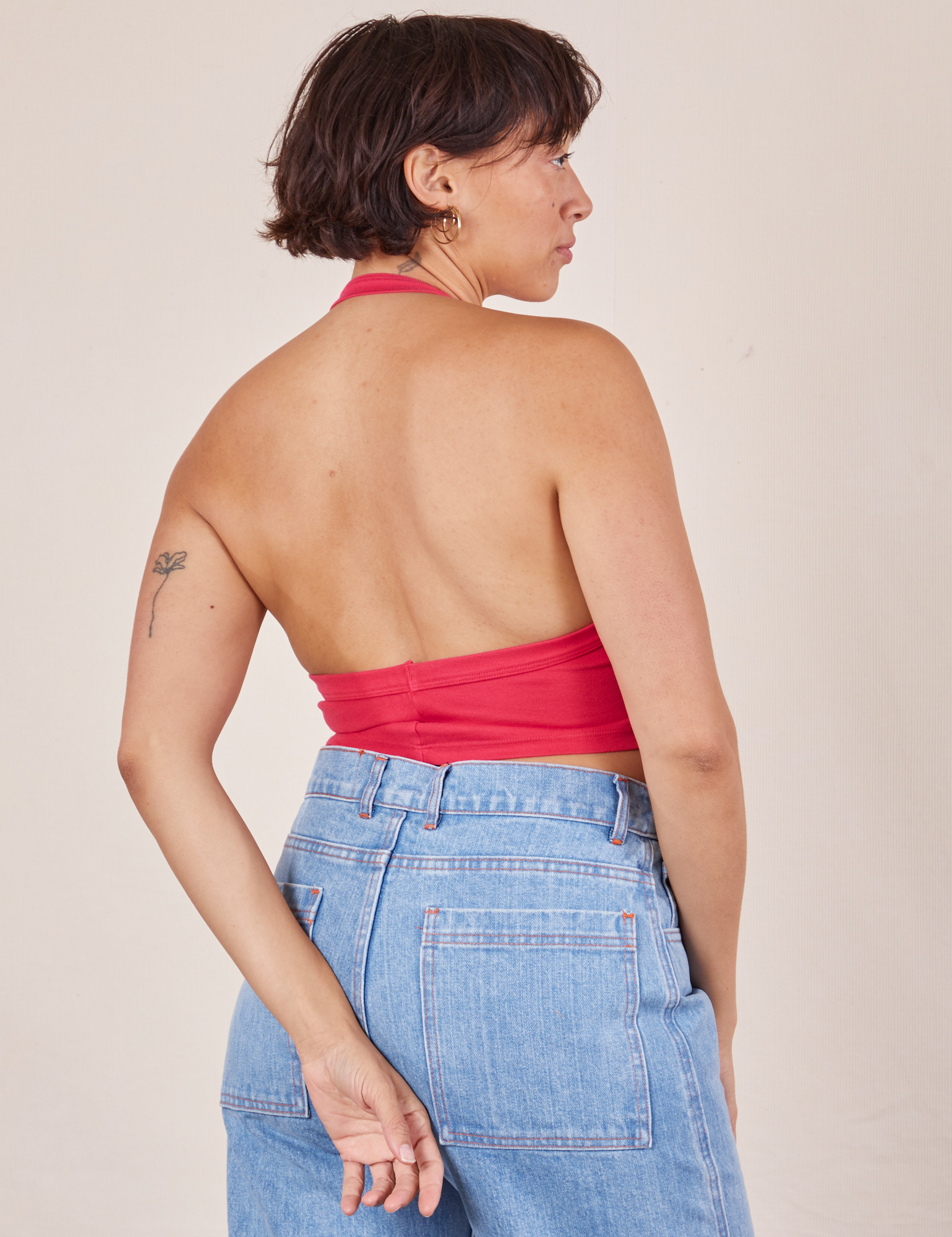 Back view of Halter Top in Hot Pink and light wash Sailor Jeans worn by Tiara