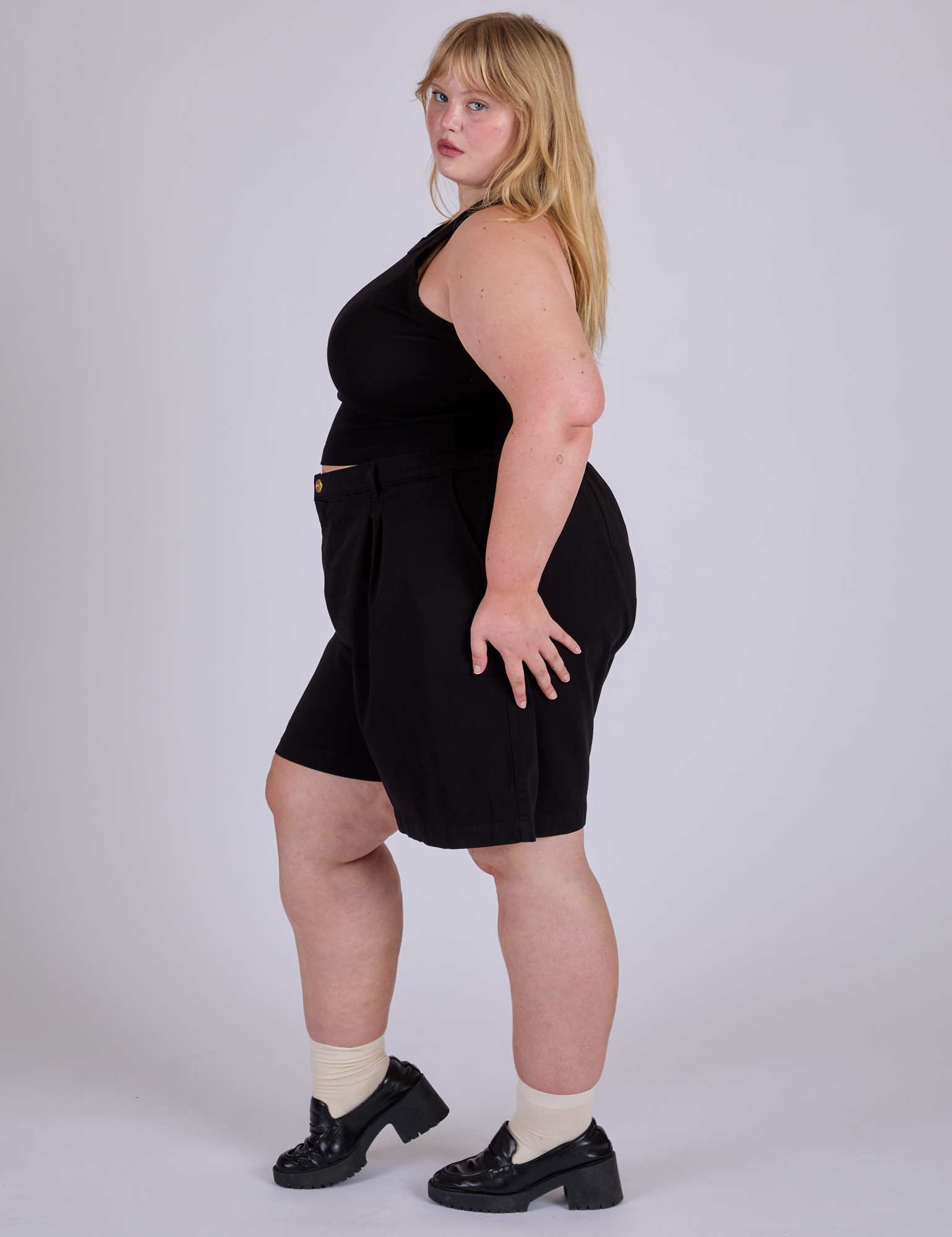 Side view of Pleated Trouser Shorts in Basic Black and black Racerback on Juliet