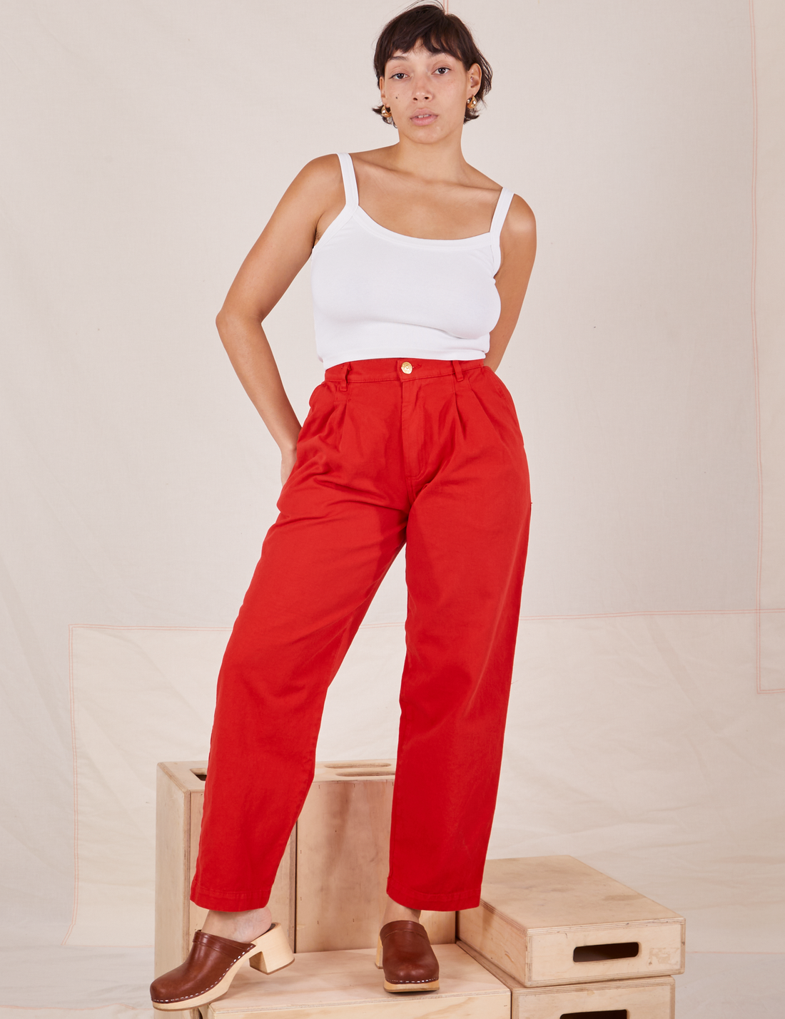 Tiara is 5'4" and wearing S Heavyweight Trousers in Mustang Red paired with vintage off-white Cropped Cami