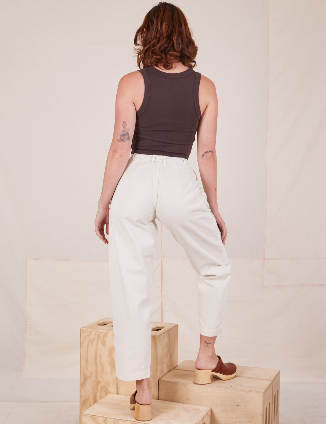 Back view of Heavyweight Trousers in Vintage Off-White and espresso brown Tank Top worn by Alex.