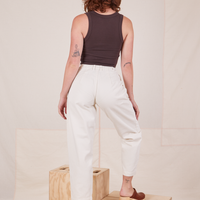 Back view of Heavyweight Trousers in Vintage Off-White and espresso brown Tank Top worn by Alex.