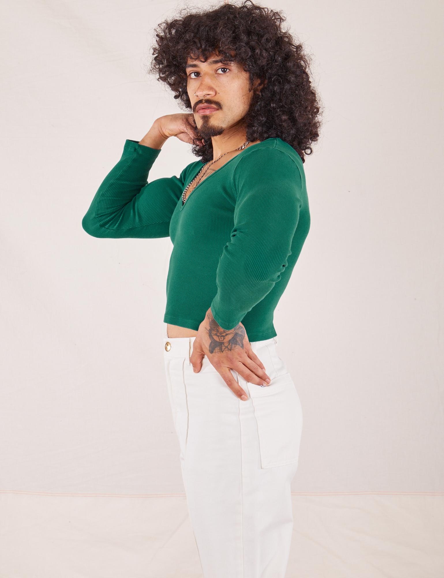 Side view of Long Sleeve V-Neck Tee in Hunter Green worn by Jesse