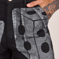 Front pocket close up of Icon Work Pants in Dice. Jesse has their hand in the pocket.